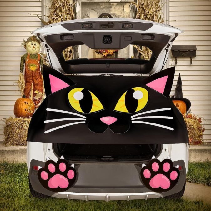 Black cat trunk or treat car with cat decorations, paw prints, and pumpkins