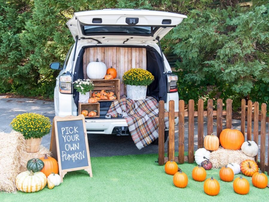 Pumpkin patch trunk or treat car with orange pumpkins and autumn decorations